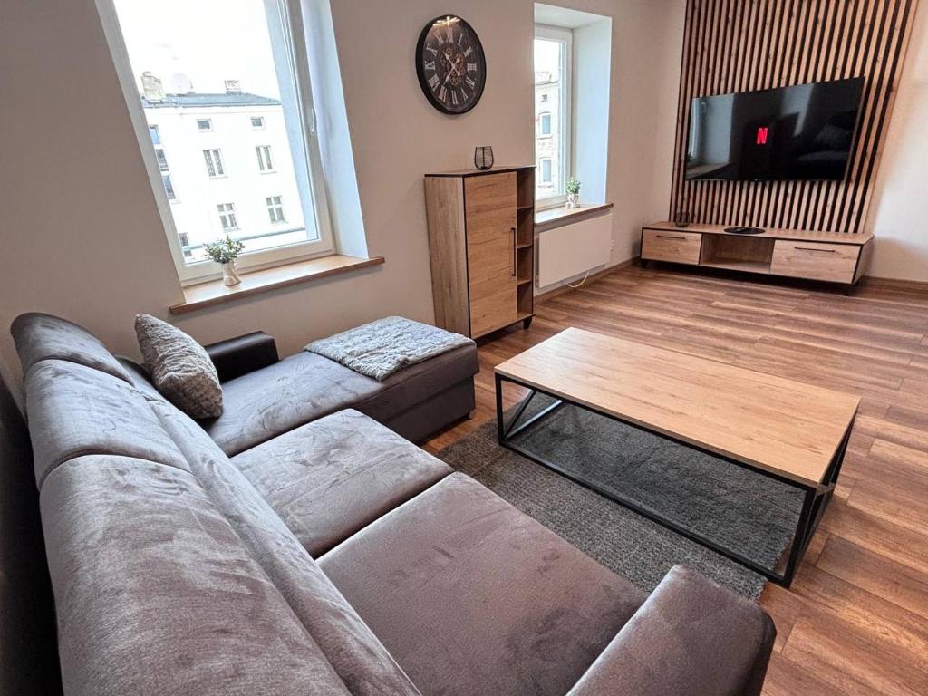 a living room with a couch and a coffee table at Kawalerka w centrum 42 in Łódź