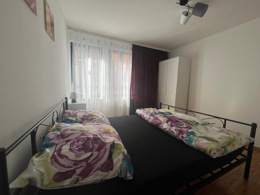 a bedroom with a bed with a flower blanket on it at Entspannen im Herzen Erfurts in Erfurt
