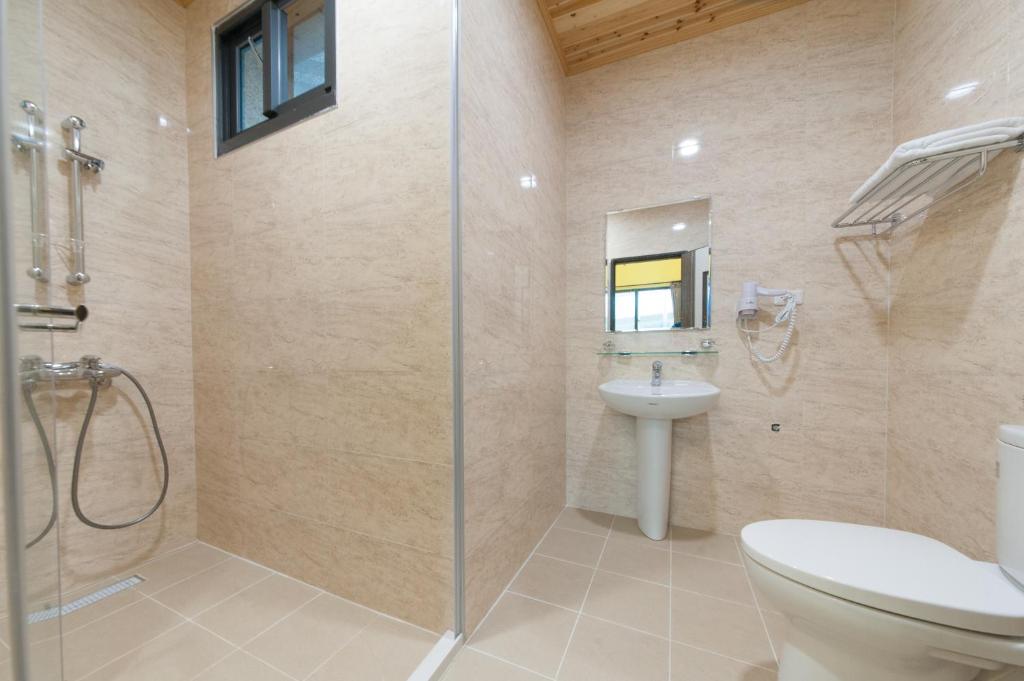 a bathroom with a shower and a toilet and a sink at EZE Homestay in Ji&#39;an