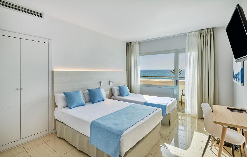 a hotel room with two beds and a view of the ocean at URH Excelsior in Lloret de Mar