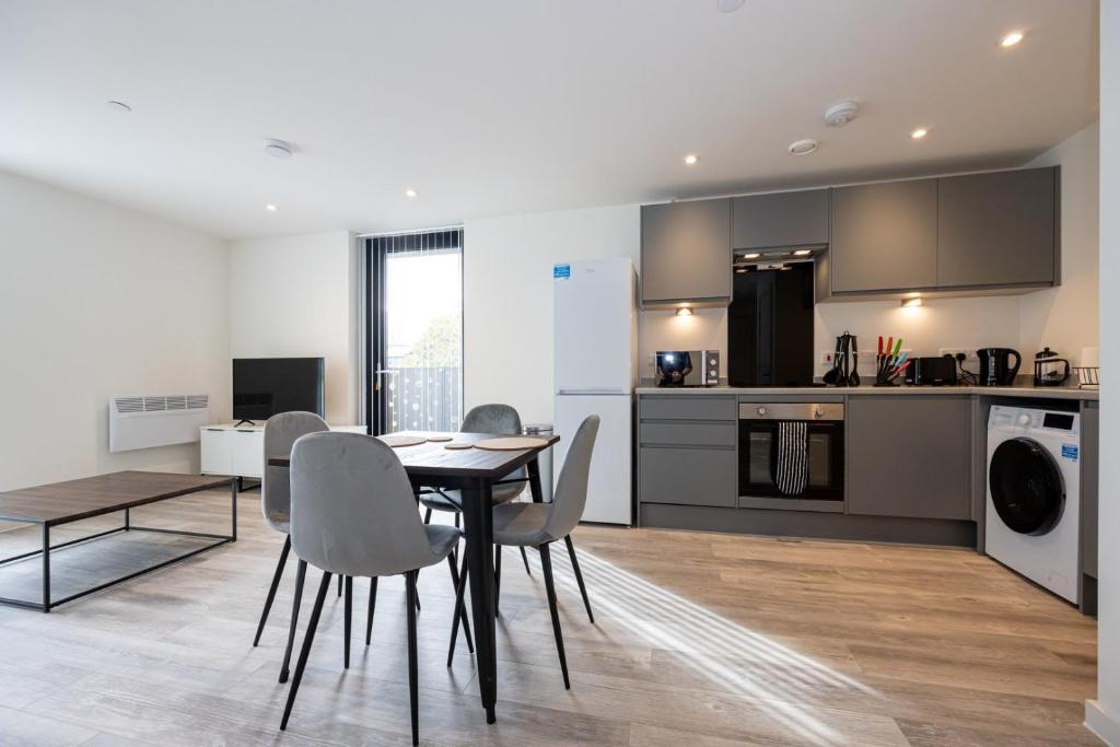 a kitchen and dining room with a table and chairs at GuestReady - Elegant Tranquility in Vauxhall in Liverpool