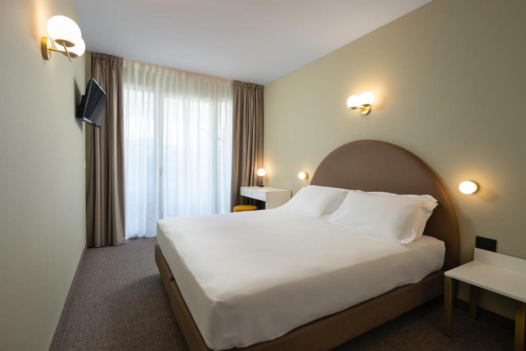 Postel nebo postele na pokoji v ubytování Hotel Nettuno