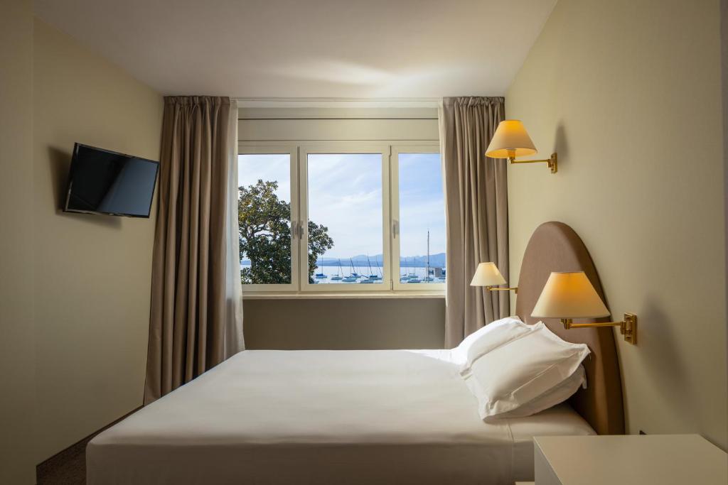 Postel nebo postele na pokoji v ubytování Hotel Nettuno