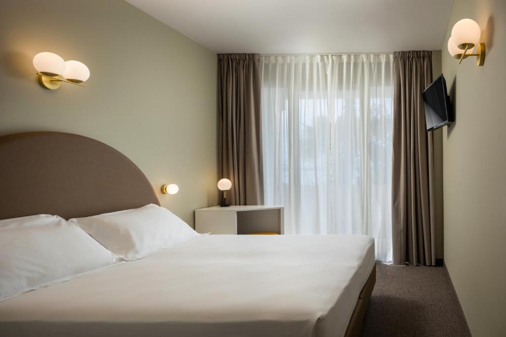 Postel nebo postele na pokoji v ubytování Hotel Nettuno