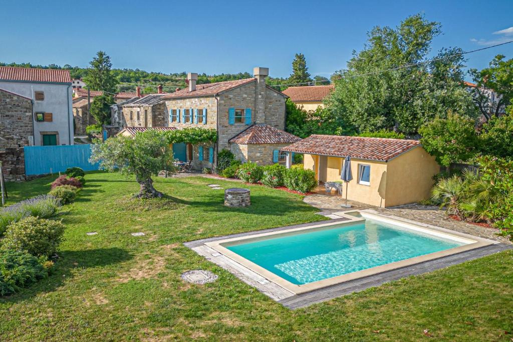 a backyard with a swimming pool and a house at Pool Villa Lavanda in Šmarje
