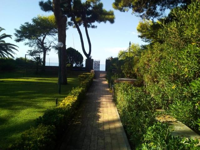 a path in a park with trees and grass at Villa Luisa B&B in Sperlonga