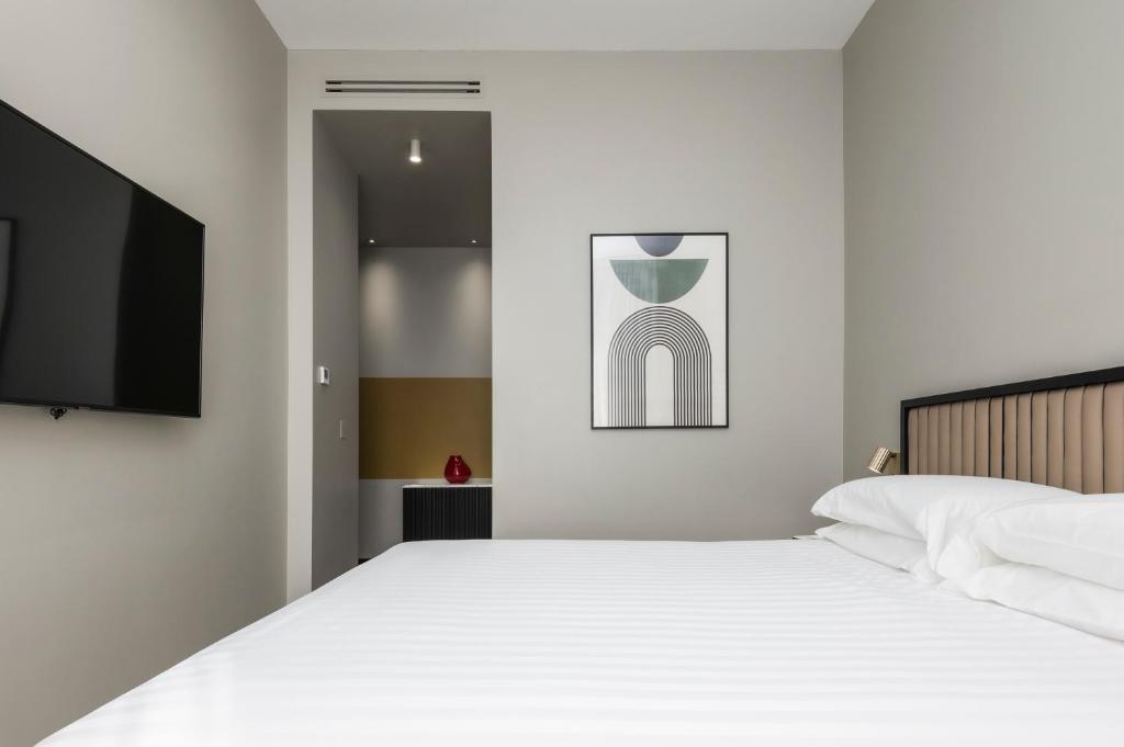 een slaapkamer met een bed en een flatscreen-tv bij Hotel Valerì in Rome