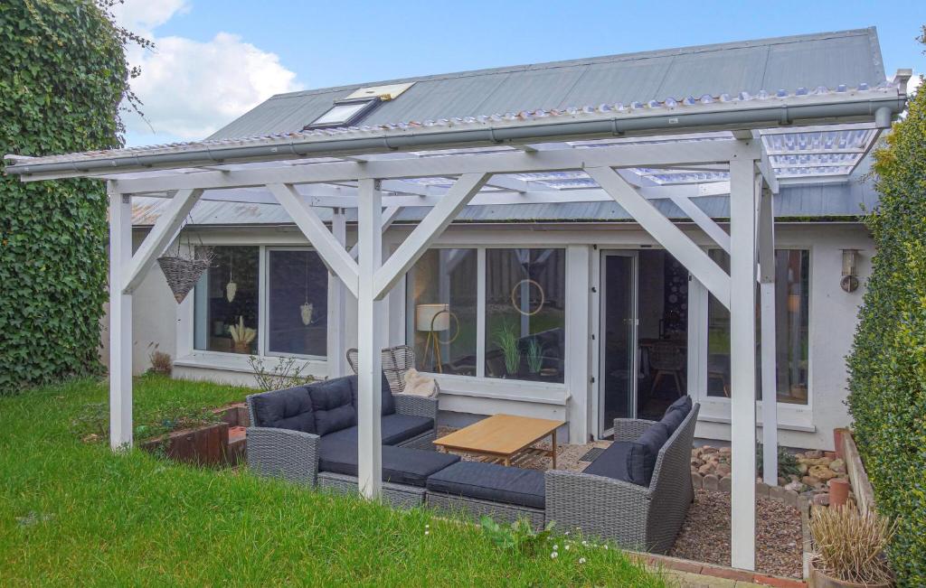 a white pergola with chairs and a table at 3 Bedroom Gorgeous Home In Otterndorf in Otterndorf