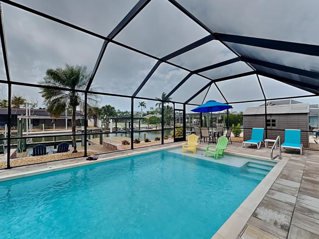 a large swimming pool with a glass roof at Tortuga Too in Fort Myers Beach