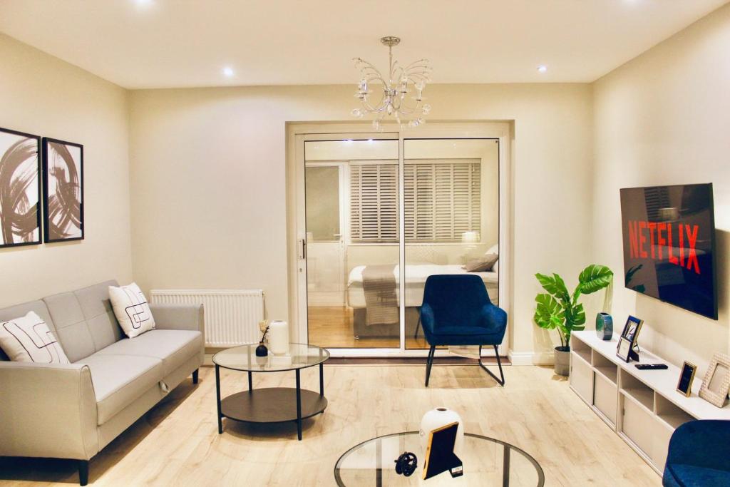 a living room with a couch and a table at A peaceful home with a garden in Reading