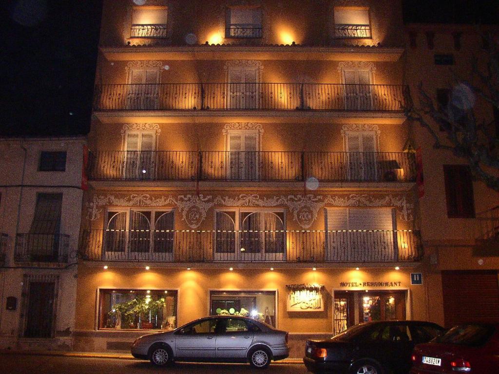 a building with a car parked in front of it at Hotel Tall de Conill in Capellades