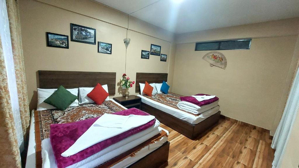 Postel nebo postele na pokoji v ubytování Indivar Homestay