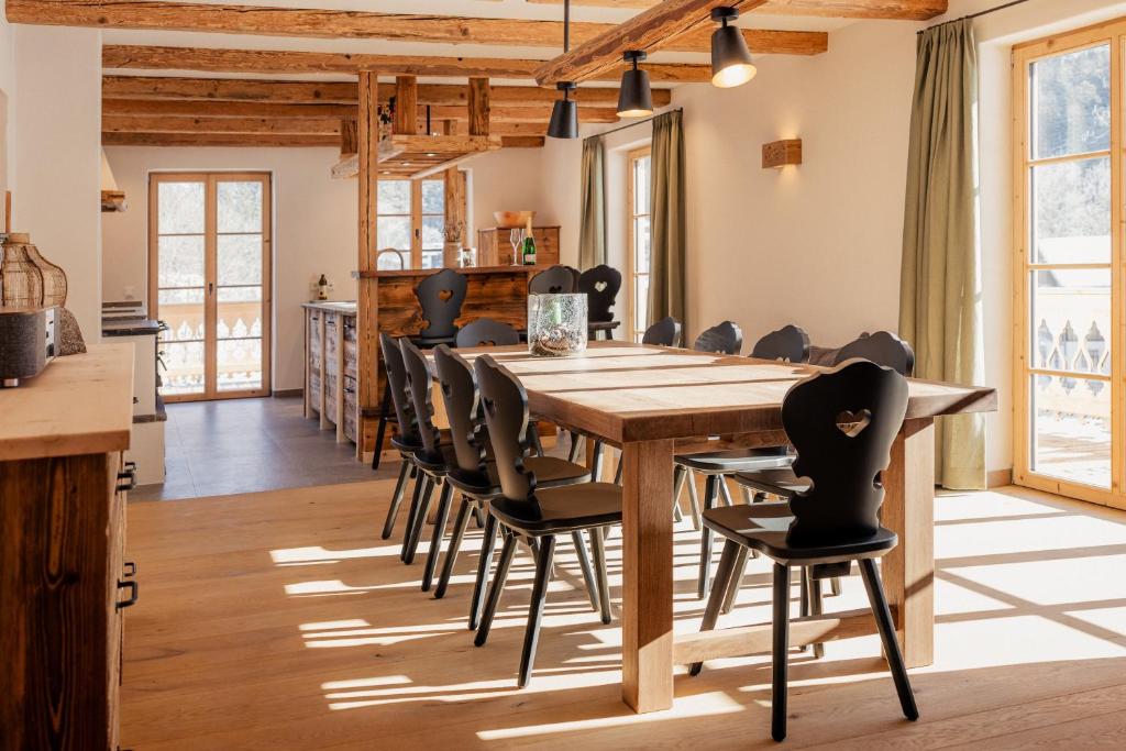 a dining room with a wooden table and chairs at Chalet in Fischbachau