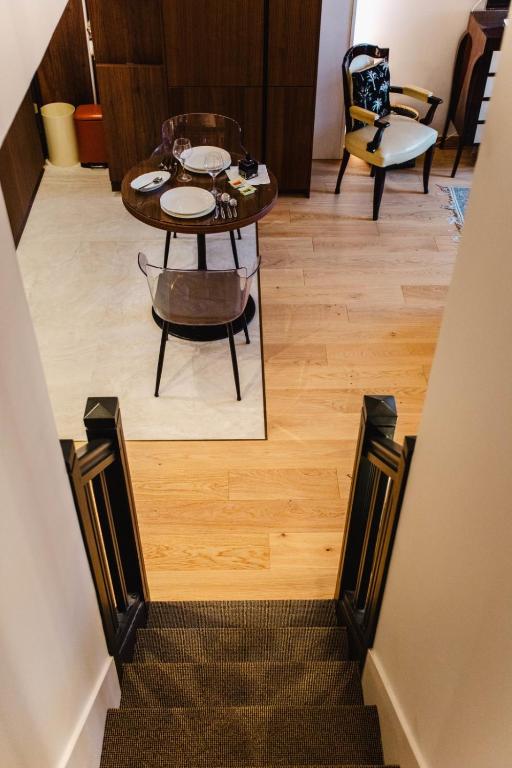 a staircase with a table and chairs in a room at Le Grand Galop - Duplex in Deauville