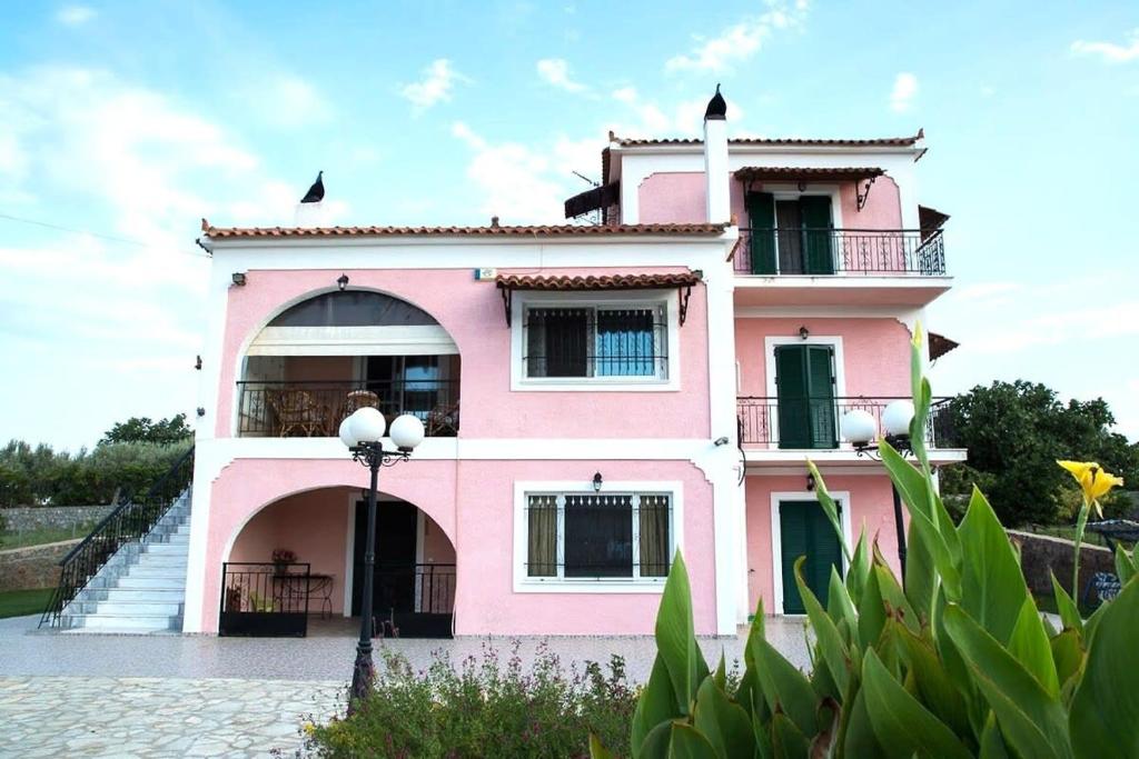 a pink house with a staircase in front of it at Dimelia Heaven Farm House in Kranidi in Kranidi