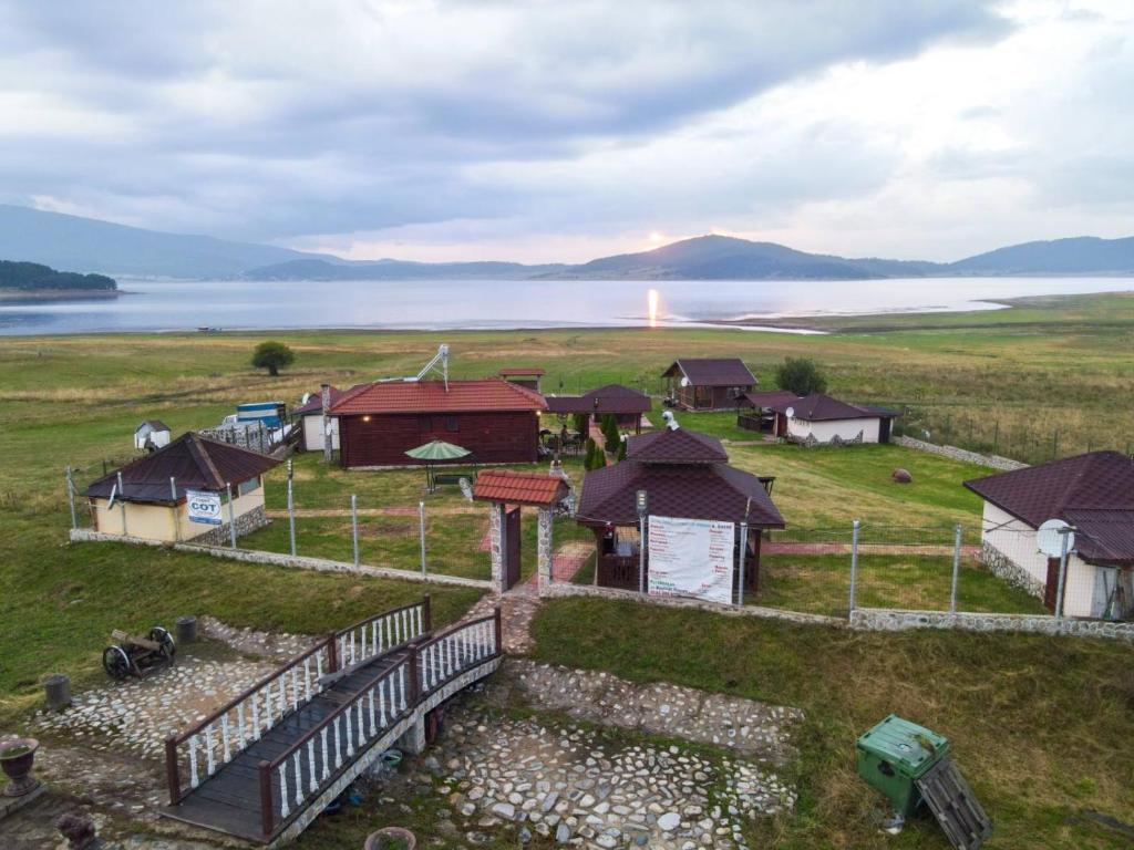 an aerial view of a farm with houses and water at Majestic Houses in Batak