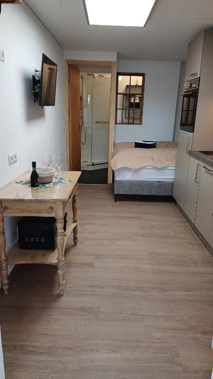 a room with a table and a bed in a room at Zimmer am See in Fußach