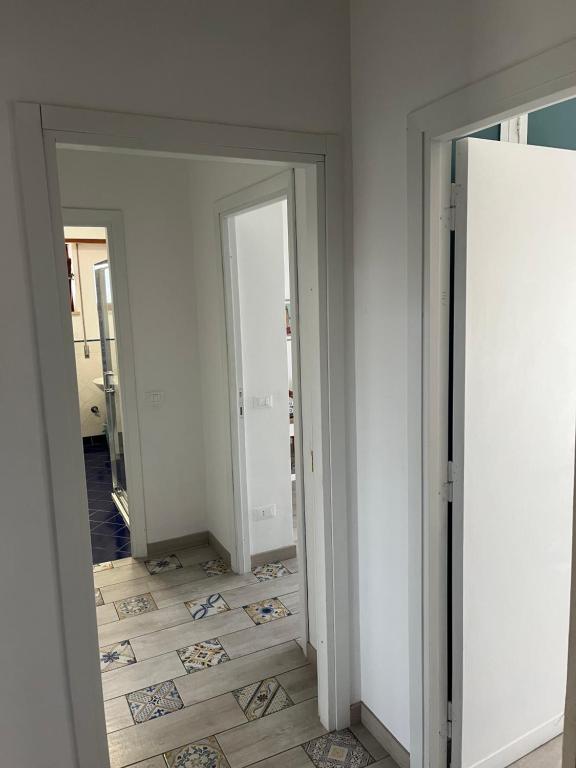 a hallway with two mirrors and a tile floor at Villa Luisa B&B in Sperlonga