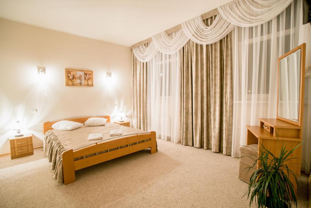 Postel nebo postele na pokoji v ubytování Dinaburg SPA Hotel