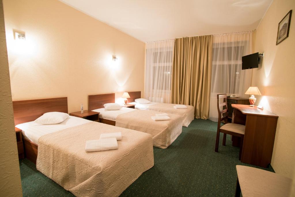 Postel nebo postele na pokoji v ubytování Dinaburg SPA Hotel