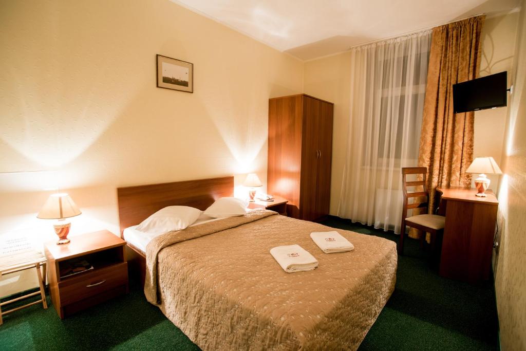 Postel nebo postele na pokoji v ubytování Dinaburg SPA Hotel