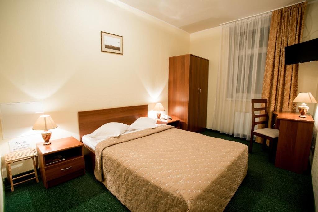 Postel nebo postele na pokoji v ubytování Dinaburg SPA Hotel