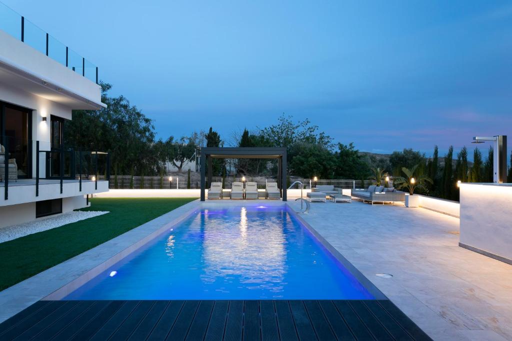 a swimming pool with a gazebo next to a house at Casa Reina Helena - welcome to a special place in Busot