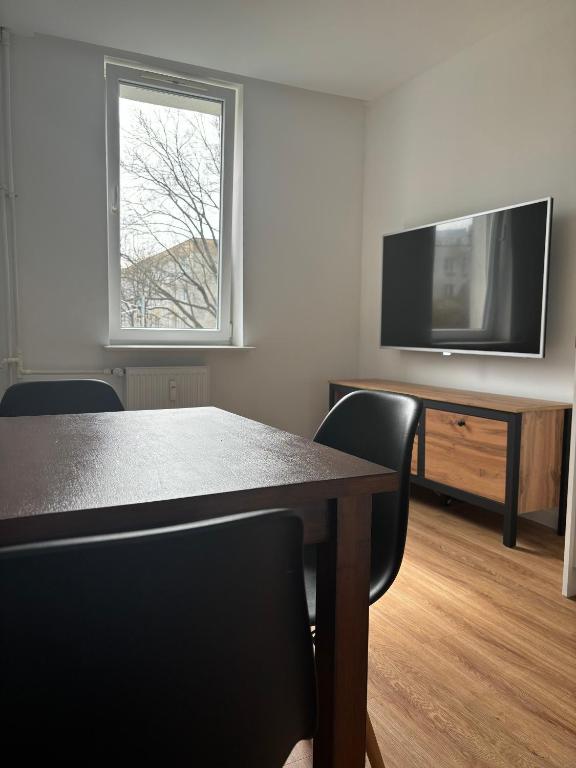 a conference room with a table and a television at Olo Apartment in Warsaw