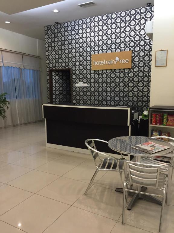 a restaurant with a table and chairs in a room at Raintree Hotel in Kuala Lumpur