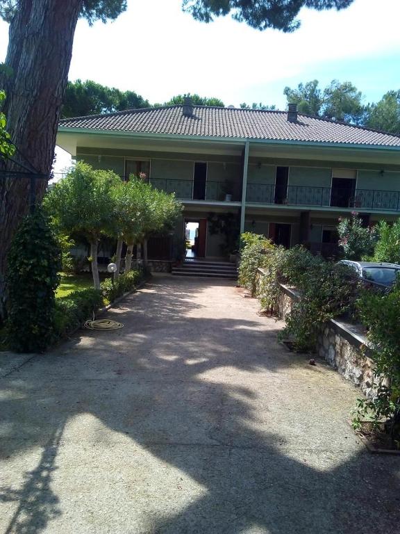 a large house with a tree in front of it at Villa Luisa B&B in Sperlonga