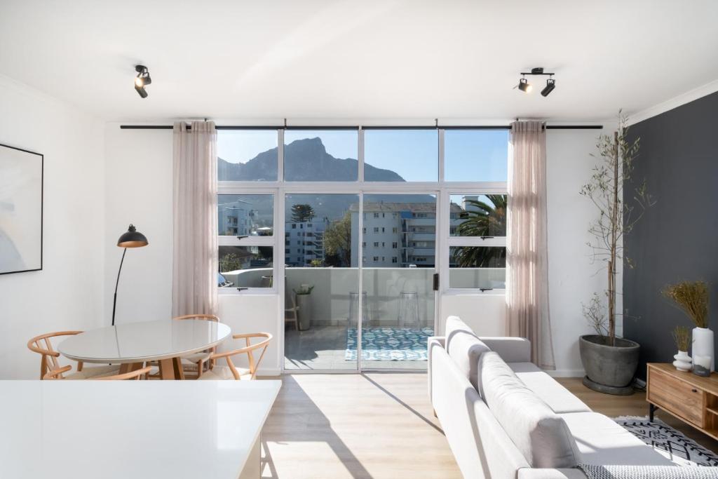 a living room with a view of the mountains at The Upper Haus Cape Town Accommodation in Cape Town