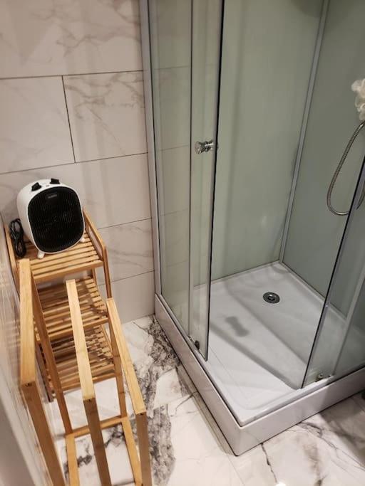 a bathroom with a shower and a chair in it at Maison de vacances - 7876 in Soulac-sur-Mer