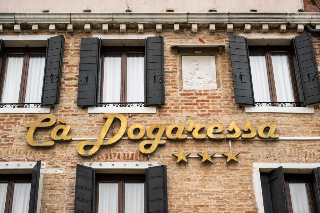 a building with a sign on the side of it at Hotel Ca' Dogaressa in Venice