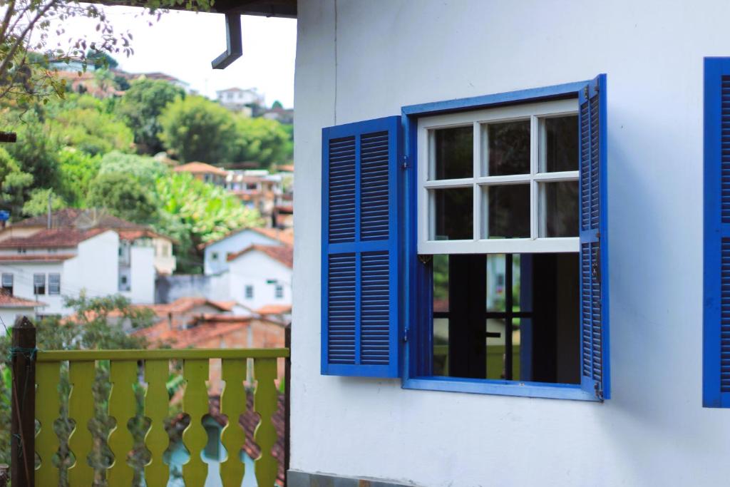 a blue window on the side of a house with a view at Casazul - OP in Ouro Preto