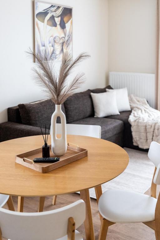 a living room with a table and a couch at Vila Sonata Palanga in Palanga