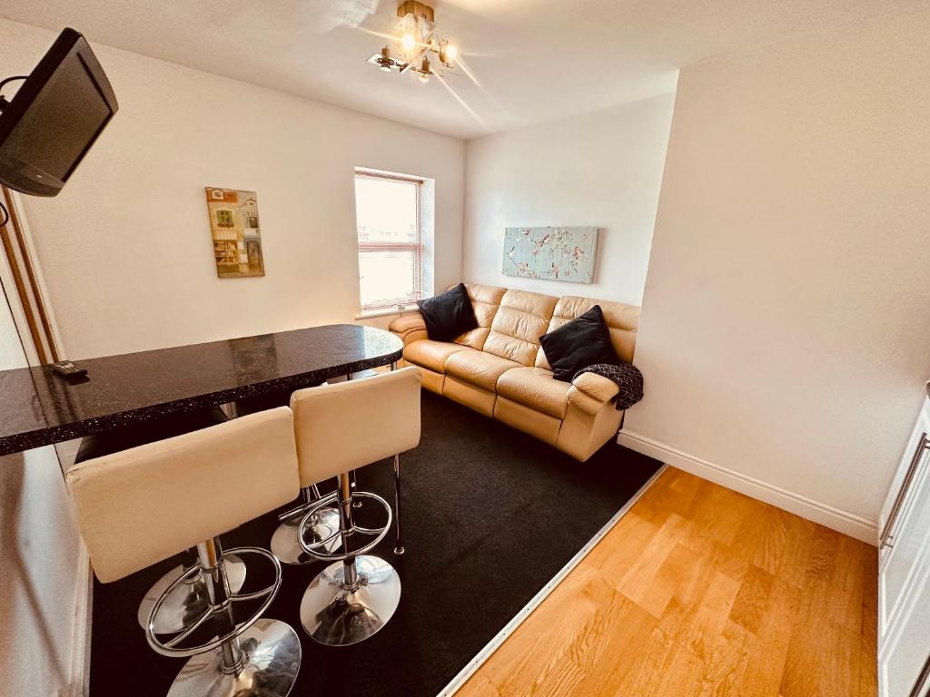 a living room with a couch and a table at Winter Gardens Flat 4 Tower view family apartment in Blackpool