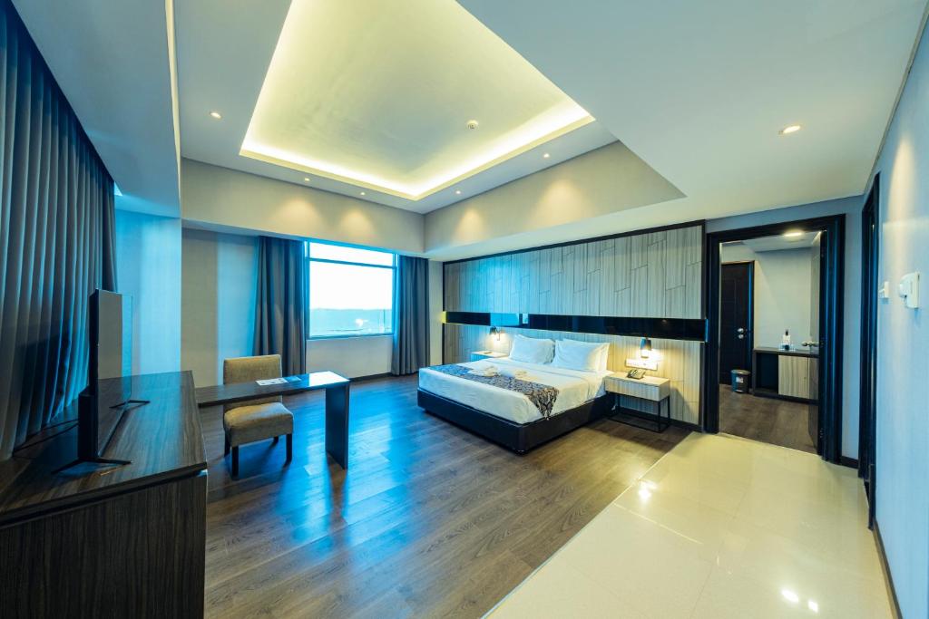 Postel nebo postele na pokoji v ubytování Grand Jatra Hotel Pekanbaru