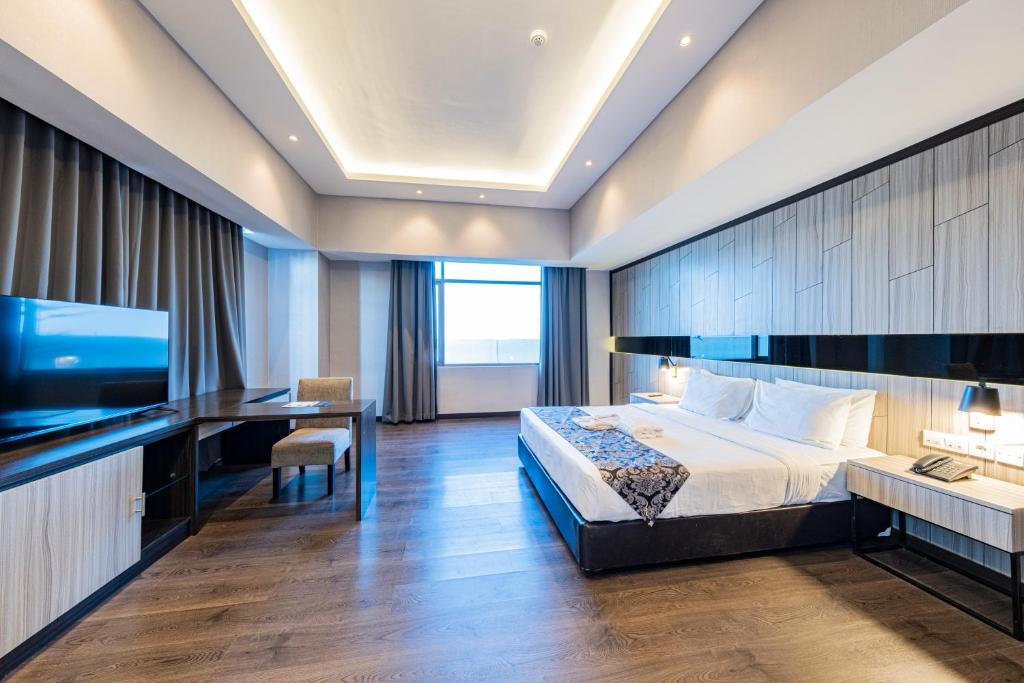 Postel nebo postele na pokoji v ubytování Grand Jatra Hotel Pekanbaru