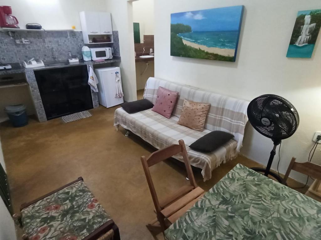 a living room with a couch and a table at Chalés Pássaros do Cerrado in Cavalcante