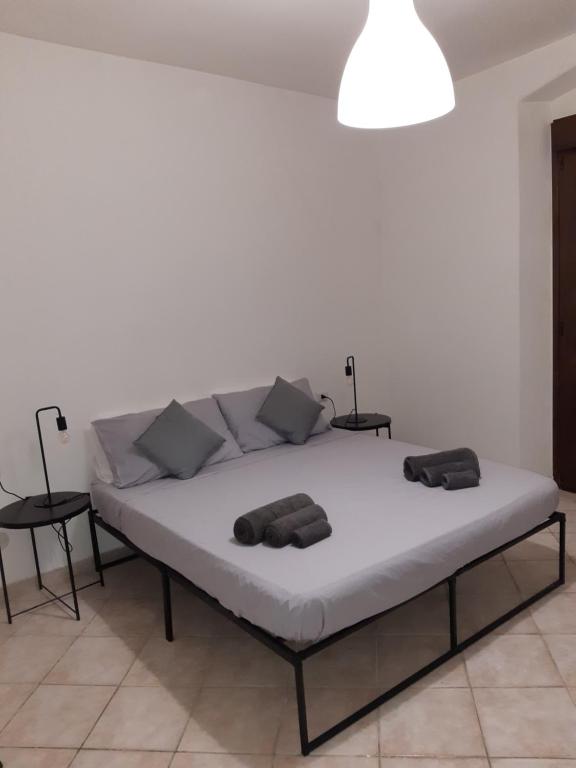 a bed in a room with two pillows on it at Repubblica 14 in Iglesias