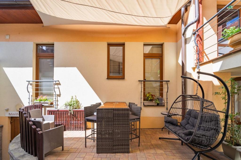 a patio with chairs and a table on a building at Apartmány KiRi in Kyjov