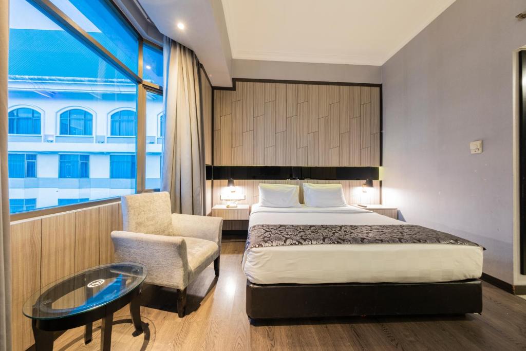 Postel nebo postele na pokoji v ubytování Grand Jatra Hotel Pekanbaru