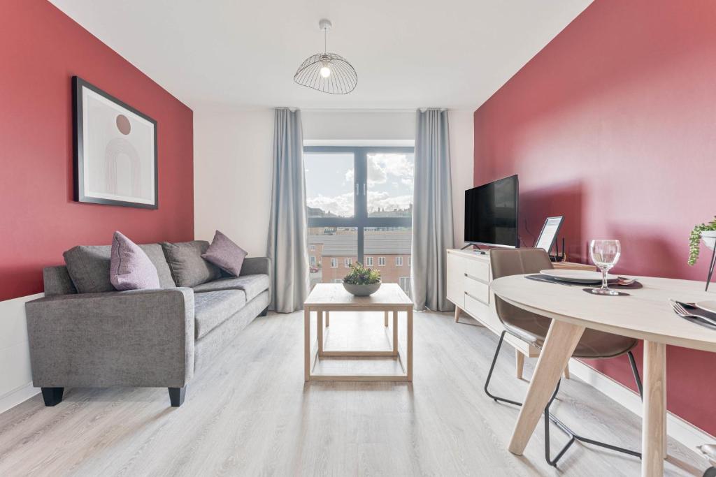 a living room with a couch and a table at Stunning 1 Bed Apartment Nightingale Quarter Derby in Derby