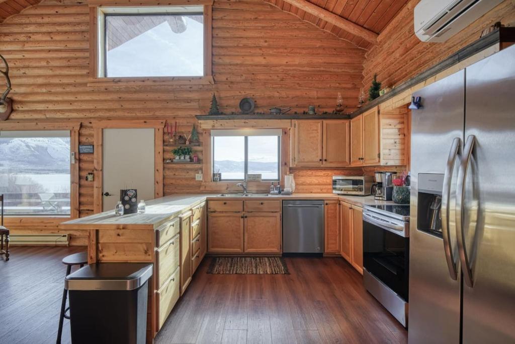 a kitchen with wooden walls and wooden floors at Trout Trap at Henry's Lake in Island Park