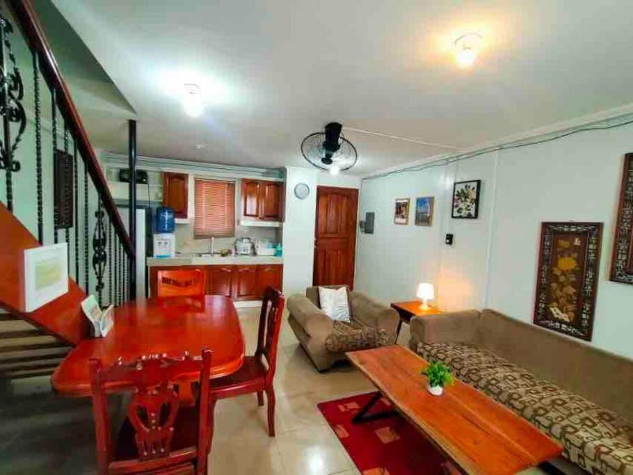 a living room with a table and a couch at 2-Bedroom/free parking/WiFi in Cainta