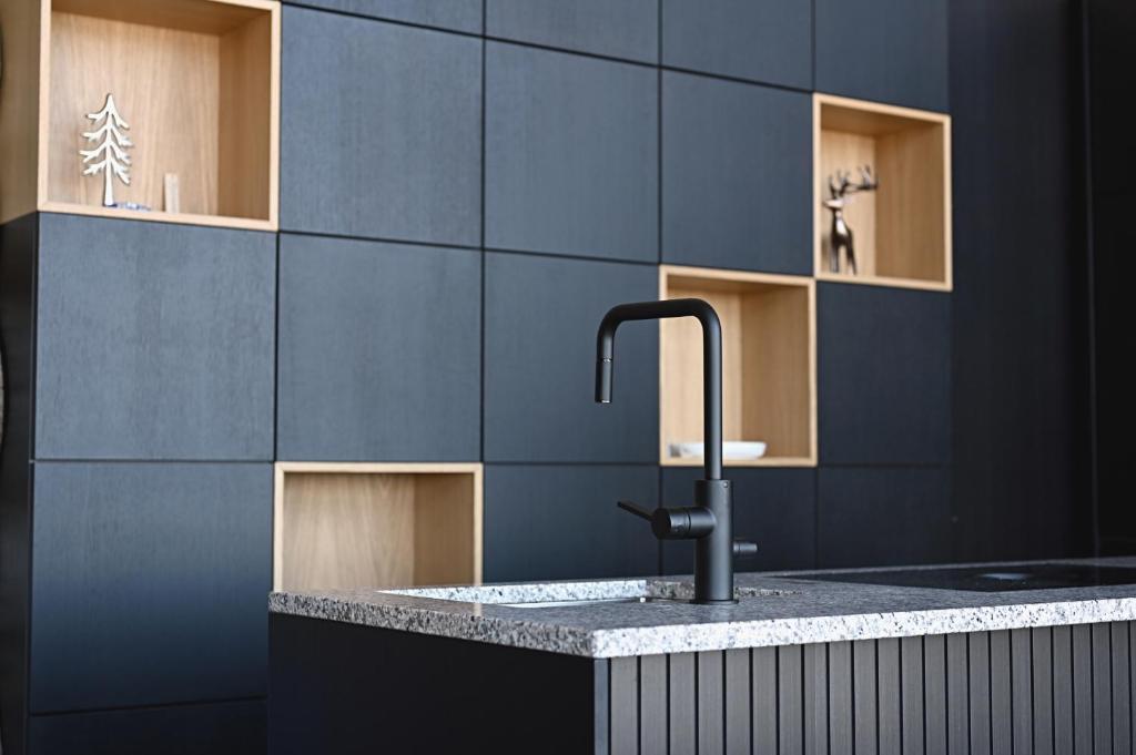 a kitchen with a sink with a faucet at Luxury Villa Utsun Otso in Levi