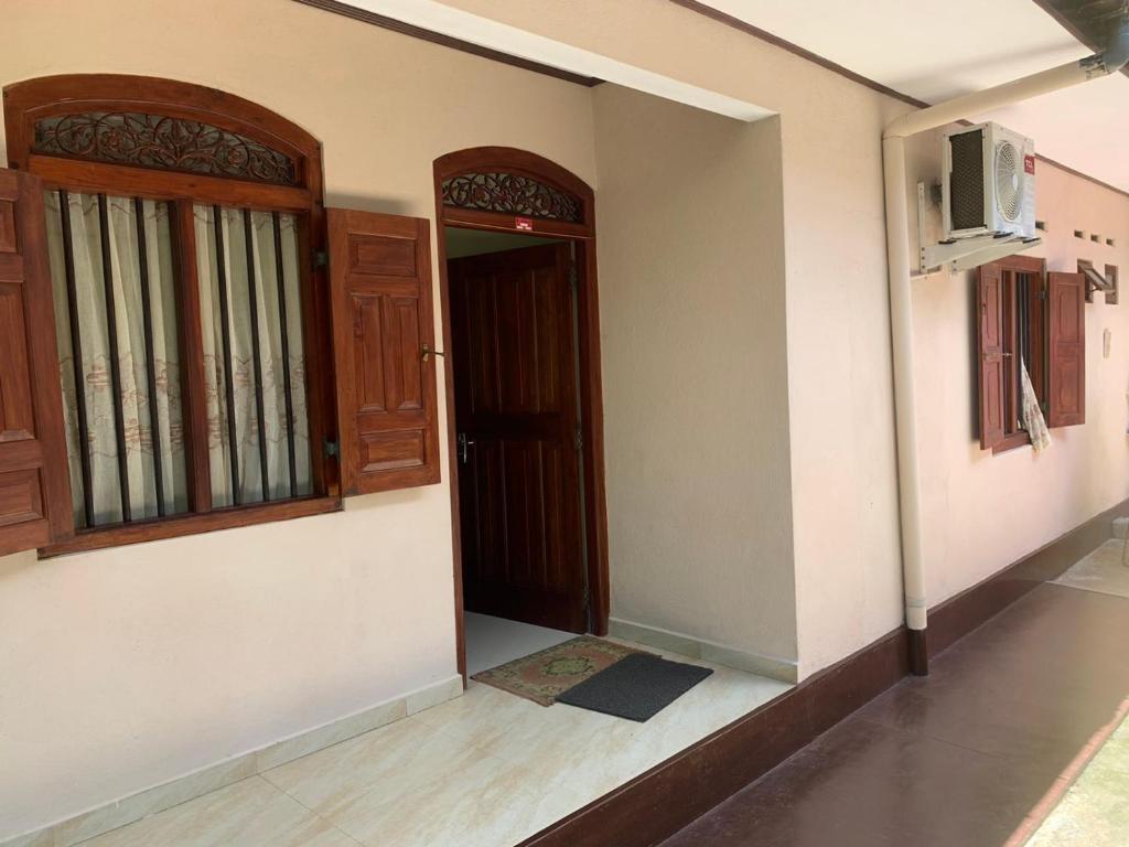 ein leeres Zimmer mit einer Tür und einem TV in der Unterkunft Cinnamon Villa AMBA in Ambalangoda