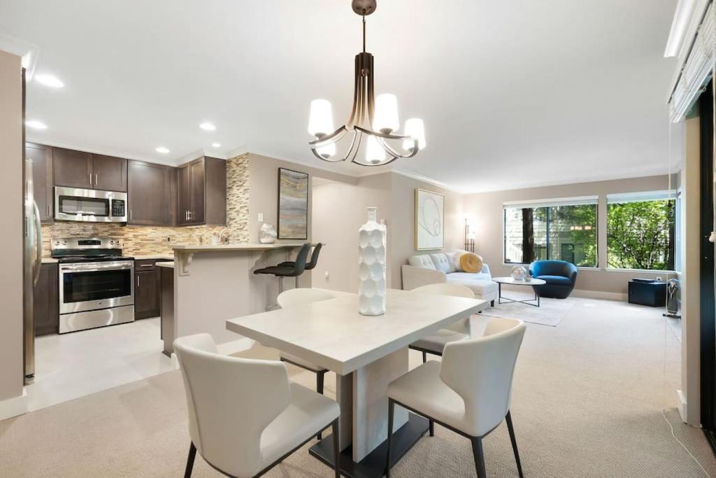 a kitchen and living room with a table and chairs at 115 Modern and Serene Min to Downtown in Bellevue