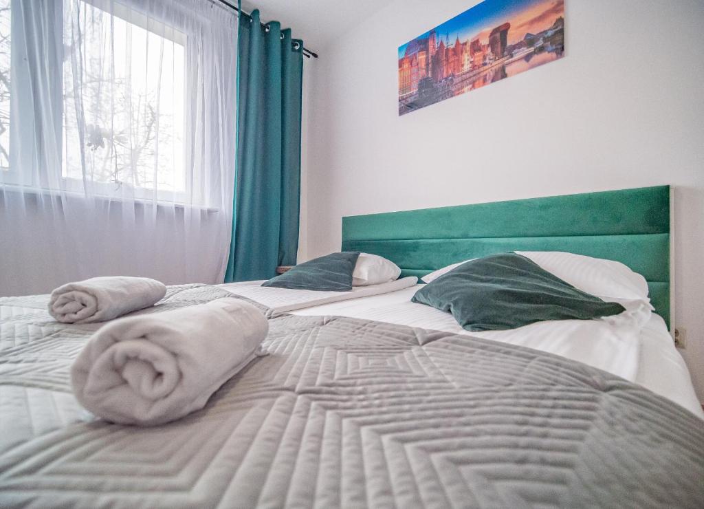 Posteľ alebo postele v izbe v ubytovaní Apartament Dworska