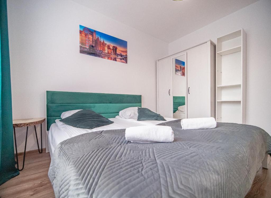 Posteľ alebo postele v izbe v ubytovaní Apartament Dworska